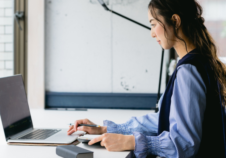 Woman sitting at laptop working